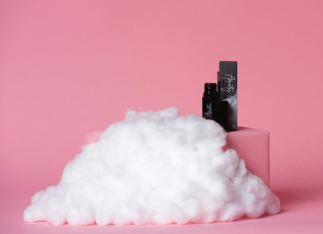 a pile of cotton sitting on top of a pink surface