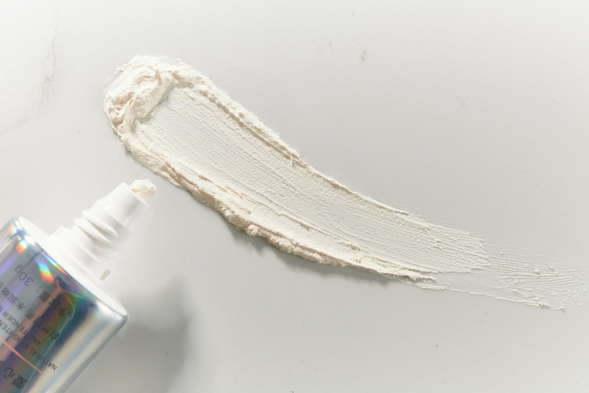 a bottle of cream next to a tube of cream