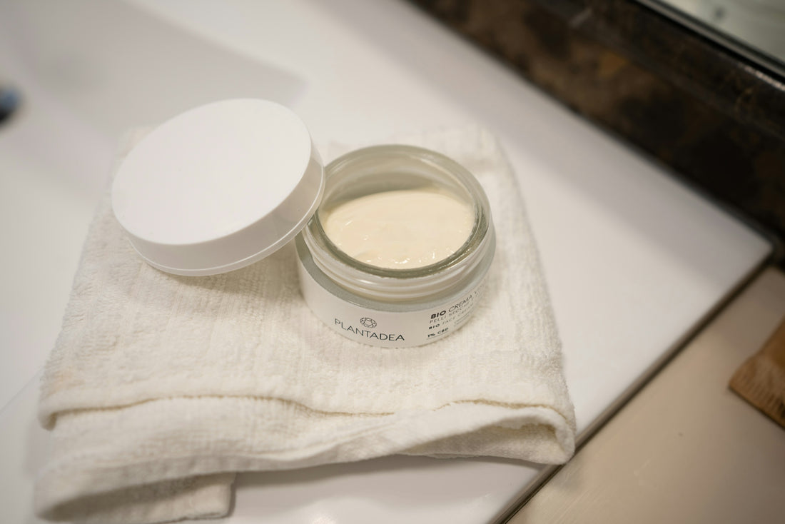 a jar of cream sitting on top of a white towel
