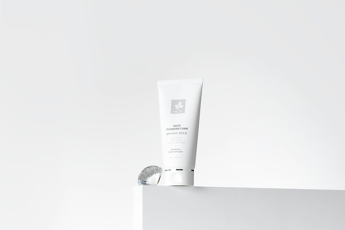 a tube of cream sitting on top of a white box
