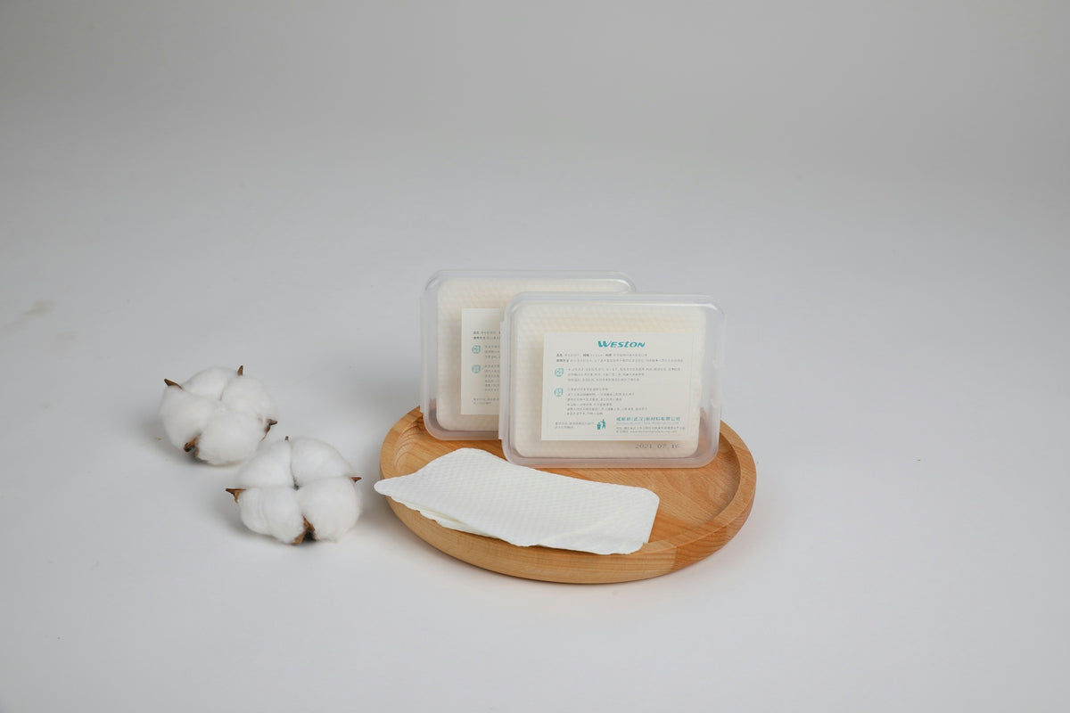 Cotton pads are presented on a wooden tray