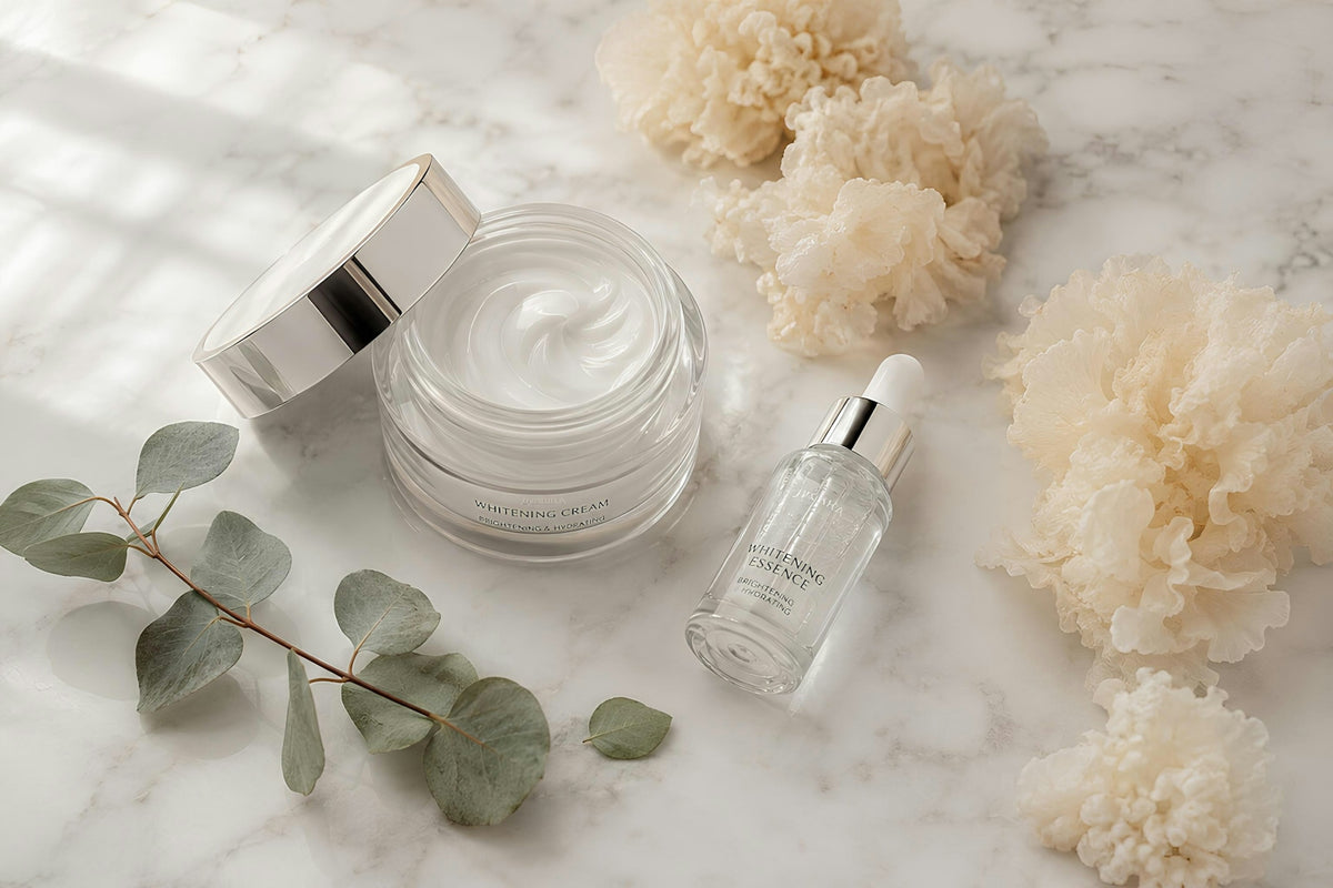 Skincare cream, serum, eucalyptus, and fluffy elements on marble